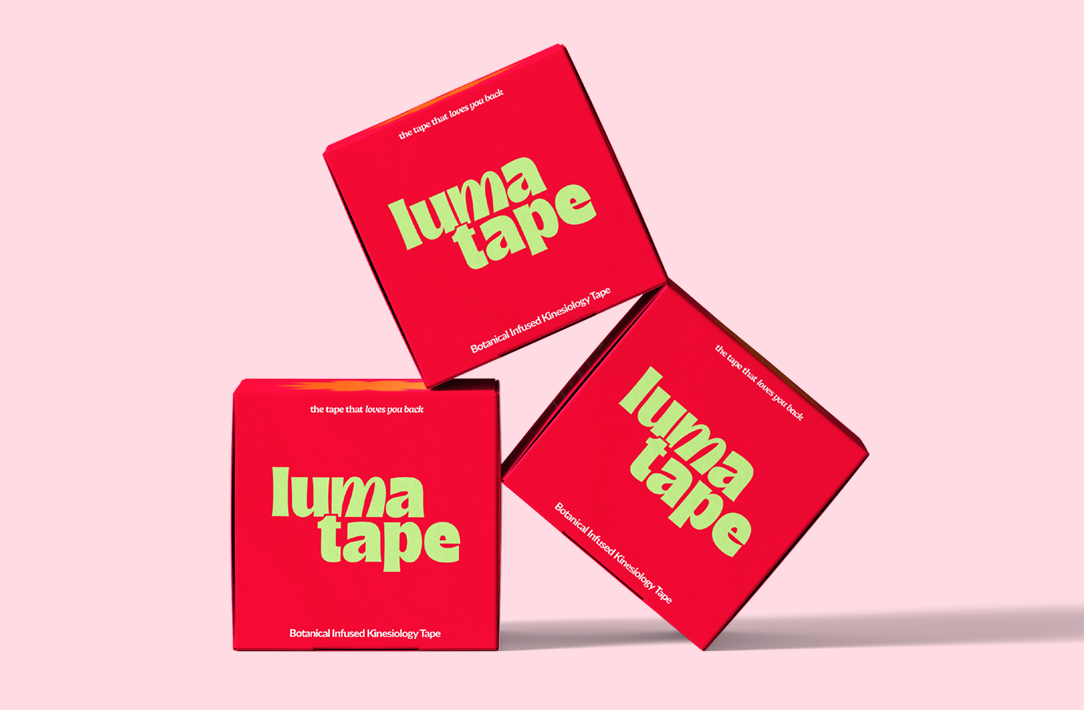 Pregnant woman using LumaTape on lower back for gentle support